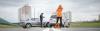 A woman on her cell calling for help after an accident