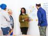 Group discussion in front of a white board with writing on it.