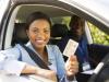 A young woman showing off her driving licence